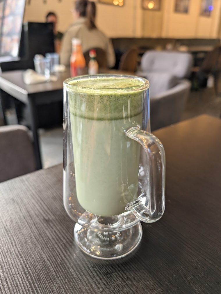 A glass mug of matcha latte